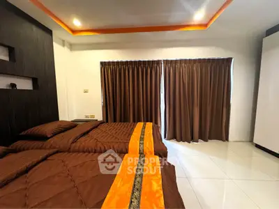 Spacious bedroom with twin beds and modern decor, featuring elegant brown curtains and ambient lighting.