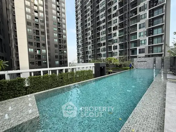 Luxurious high-rise apartment complex with stunning outdoor pool and modern architecture.