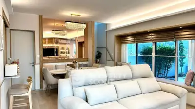 Luxurious living room with elegant decor and large windows offering garden view