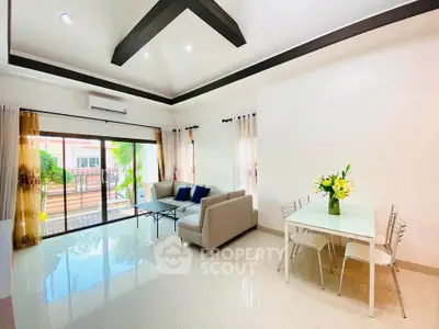Spacious modern living room with elegant decor and garden view, perfect for relaxation and entertaining.