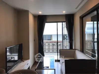 Modern living room with balcony access and stylish furniture in a contemporary apartment.