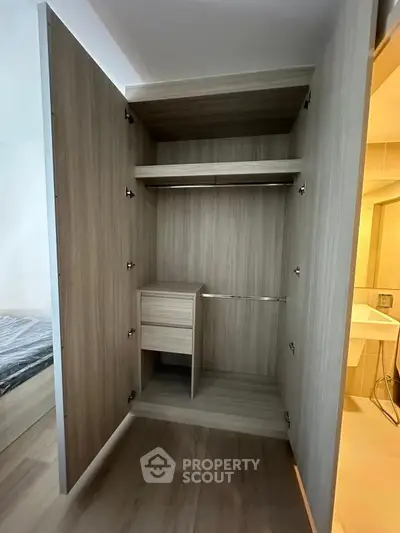 Spacious wooden wardrobe with open doors in modern bedroom setting