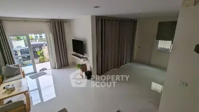 Spacious modern living room with large windows and stylish decor