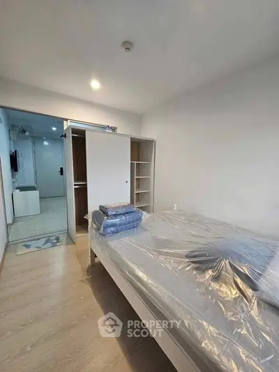 Modern bedroom with sleek design and ample storage in a stylish apartment.