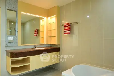 Modern bathroom with elegant vanity and bathtub in a stylish real estate property.