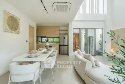 Modern open-plan living and dining area with stylish decor and natural light