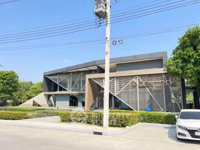 Modern commercial building with unique architectural design and large glass windows.