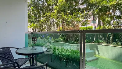Charming balcony with lush garden view and cozy seating area