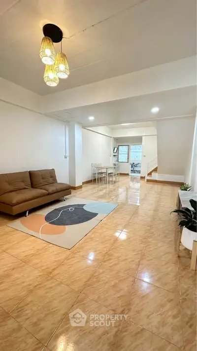 Spacious living room with modern decor and elegant lighting