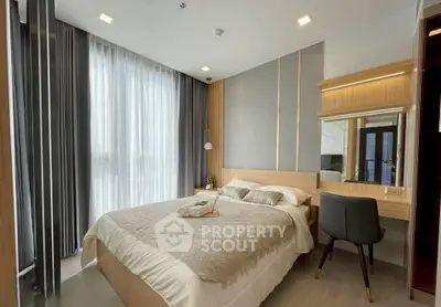 Modern bedroom with elegant decor and large window for natural light