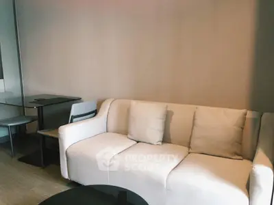 Modern living room with cozy white sofa and sleek dining area