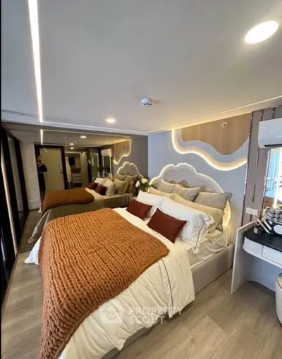 Luxurious modern bedroom with stylish decor and cozy ambiance, featuring elegant lighting and plush bedding.