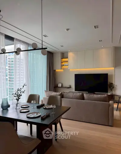 Modern living room with elegant dining area and large TV, featuring floor-to-ceiling windows and stylish decor.