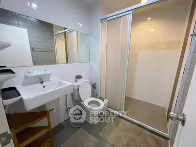 Modern bathroom with sleek fixtures and spacious shower area