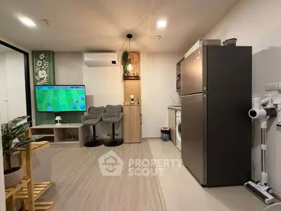 Modern living room with sleek appliances and stylish decor, featuring a wall-mounted TV and cozy seating area.