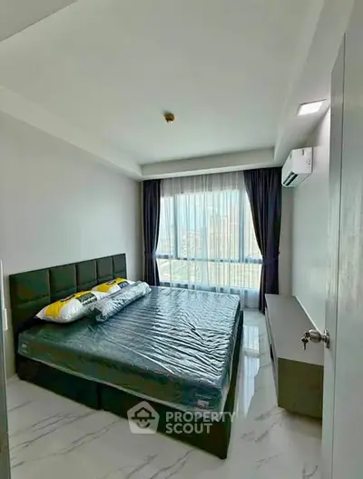 Modern bedroom with large window and air conditioning in a stylish apartment.