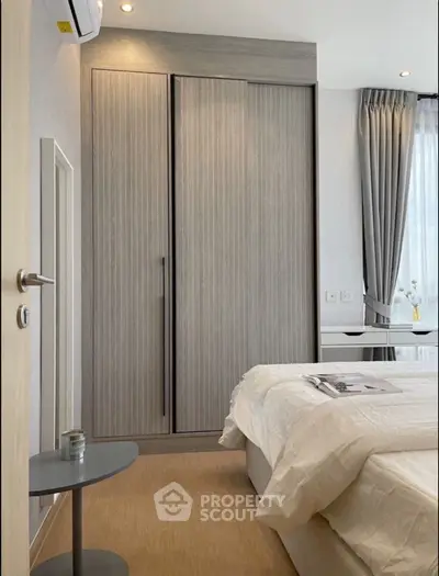 Modern bedroom with sleek wardrobe and cozy decor