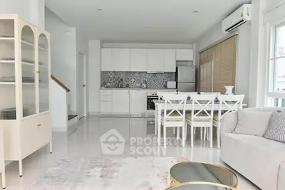 Modern open-plan living room with sleek kitchen and stylish dining area