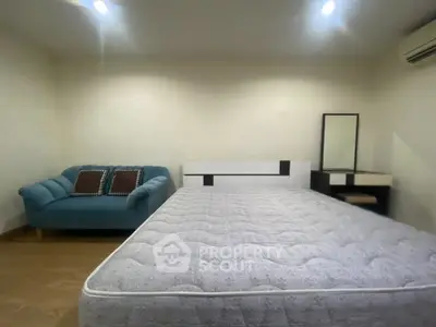 Spacious bedroom with modern furniture and cozy ambiance