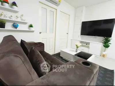 Modern living room with plush brown sofa, wall-mounted TV, and stylish decor accents.