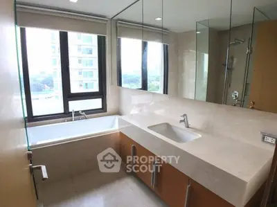 Modern bathroom with large window and bathtub in luxury apartment