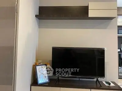 Modern living room with sleek TV setup and stylish shelving