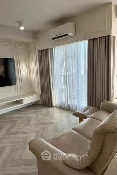 Luxurious living room with elegant herringbone flooring and modern air conditioning unit.