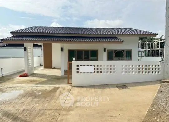 Charming single-story house with modern design and spacious driveway in a serene neighborhood.