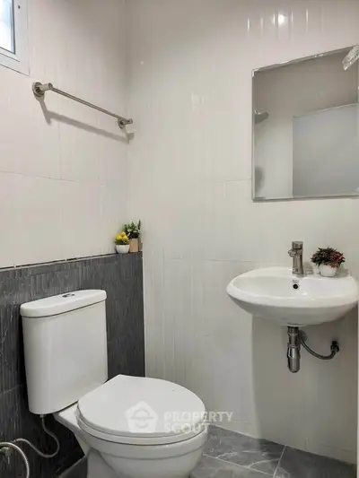 Modern minimalist bathroom with sleek fixtures and neutral tones.