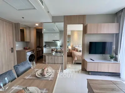 Modern open-plan living room with kitchen and bedroom view