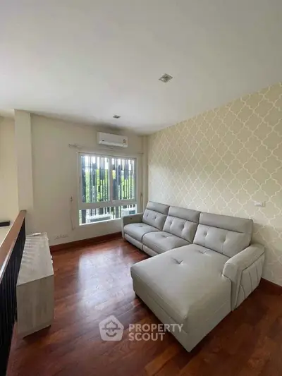 Modern living room with stylish sofa and wooden flooring