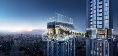 Luxurious high-rise building with rooftop pool and stunning city views at sunset.