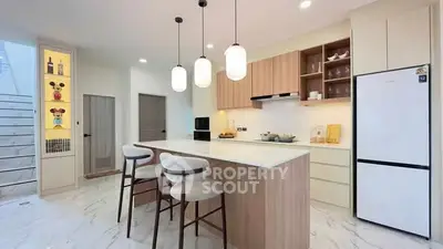 Modern kitchen with island, pendant lights, and sleek cabinetry