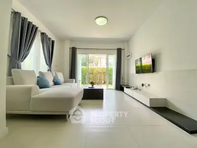 Spacious modern living room with large windows and stylish decor