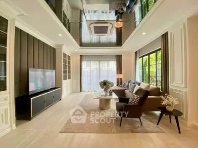 Luxurious living room with elegant decor, large windows, and modern furniture in a stylish home.