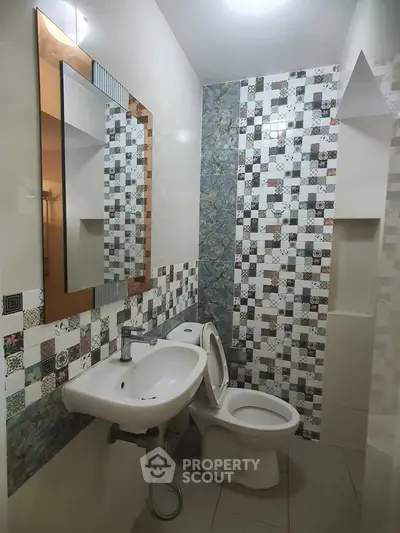 Modern bathroom with stylish mosaic tiles and sleek fixtures