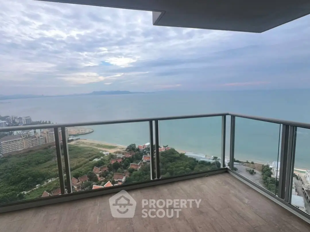 Stunning ocean view from a spacious balcony in a high-rise apartment.