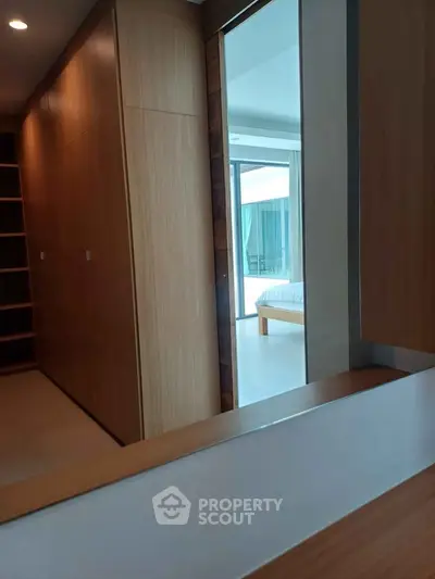 Modern bedroom with wooden accents and open closet space