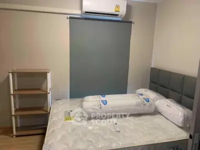Cozy bedroom with air conditioning and modern furnishings in a stylish apartment.