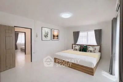 Spacious modern bedroom with elegant decor and natural light