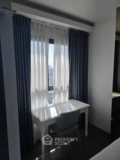 Bright study nook with elegant curtains and city view