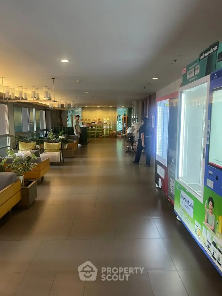 Modern building hallway with vending machines and seating area
