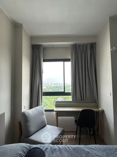 Cozy bedroom with study area and scenic window view