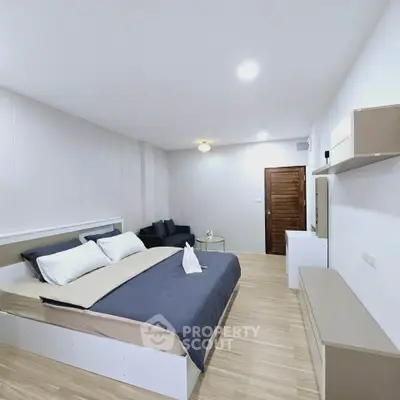 Spacious modern bedroom with stylish decor and cozy ambiance