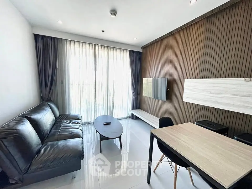 Modern living room with sleek furniture and large windows for natural light.