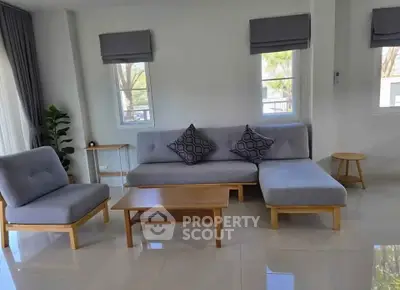 Modern living room with stylish gray furniture and natural light