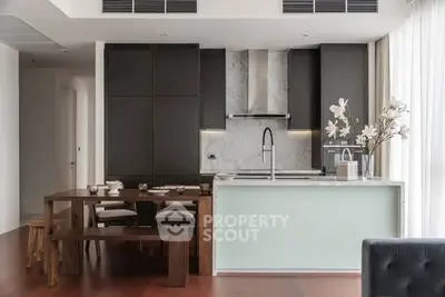Modern kitchen with sleek design, marble countertops, and elegant dining area.