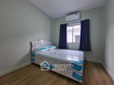 Cozy bedroom with elegant bed and air conditioning, perfect for restful nights.
