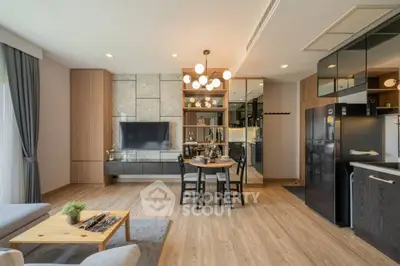 Modern open-plan living room with stylish decor and sleek kitchen area.