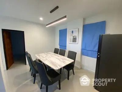 Modern dining area with marble table and stylish chairs in a contemporary home